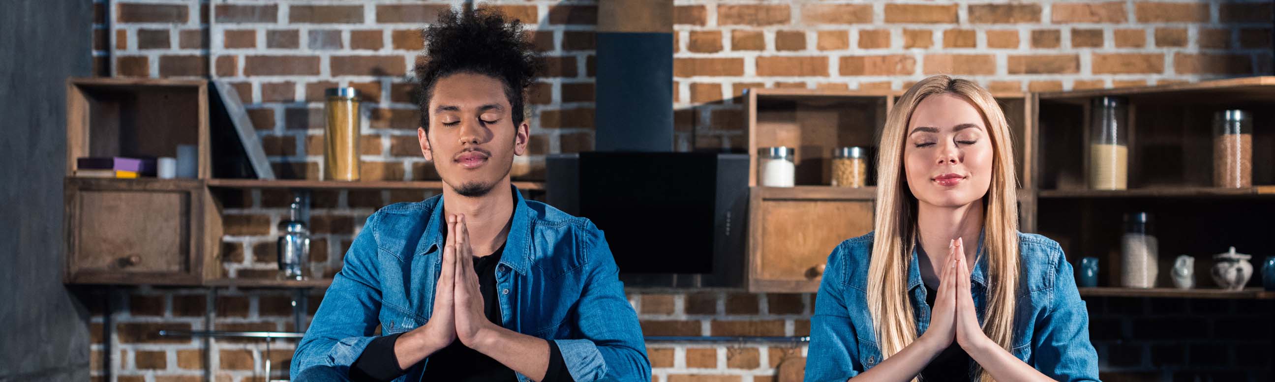 a sun flare shining through tree branches in a lush green forest